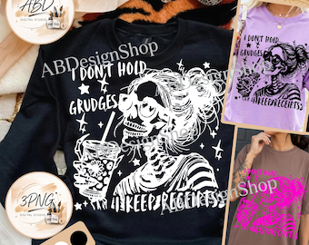 May include: A black long-sleeve sweatshirt featuring a white graphic of a skeleton with a messy bun and sunglasses holding a drink, with the text I DON'T HOLD GRUDGES I KEEP RECEIPTS. The design is also shown on a light purple and a brown t-shirt.