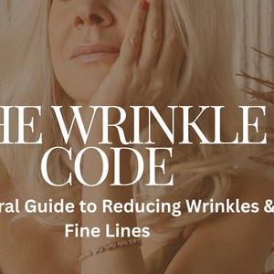 May include: Image shows the text "THE WRINKLE CODE" above "A Natural Guide to Reducing Wrinkles & Fine Lines." A woman with blonde hair is touching her face. The background has a neutral colour palette with dried plants.