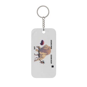 May include: A rectangular white keychain with a metal ring and chain. The design features a lion, a human brain, and a small figure, with the text "LARGER THAN LIFE" and "SOUND MIND SOUND BODY" printed in black lettering on the surface.