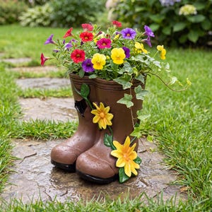 May include: A brown boot-shaped planter featuring raised yellow flower decorations on the side. The planter is filled with a variety of colorful small flowers including red, yellow, purple, and white blossoms, along with green ivy foliage.