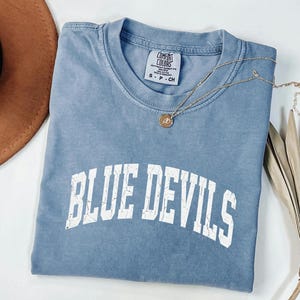 May include: A handmade wooden sign with the text "Welcome" in a handwritten style. The sign is painted white with a distressed finish, and a green leafy garland is attached to the top. The sign is designed for indoor or outdoor use.