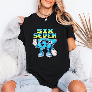 May include: Black t-shirt with the text "SIX SEVEN" in pixelated blue and yellow letters. The number seven is a cartoon character with arms, legs, and shoes. The character is giving a peace sign.