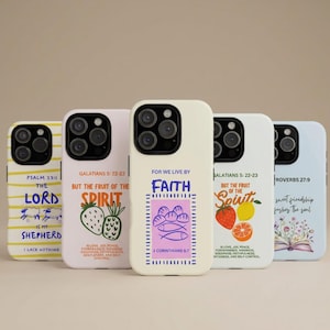 May include: Five smartphone cases featuring various religious quotes and illustrations. Designs include yellow stripes with sheep, a pink case with fruit, a cream case with fish and bread, a white case with fruit, and a light blue case with flowers.
