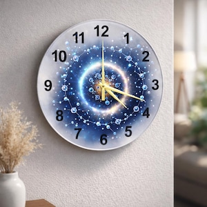May include: A round wall clock with a blue and white galaxy design. The clock face features black numerals and gold hands. The design includes a central glowing circle and interconnected dots.