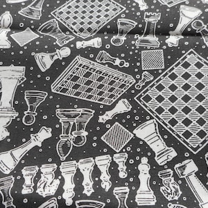 May include: Black and white chess-themed fabric featuring various chess pieces, chessboards, and a chess clock. The design includes rooks, pawns, bishops, and other pieces, along with checkered squares and small white dots. The fabric has a dark background.