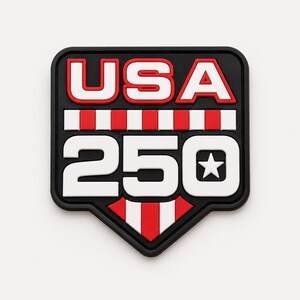 May include: A black, red, and white USA 250 patch. The word "USA" is in white with a red outline, above the number "250" in white with a star. The patch has a black border and a red and white striped design.