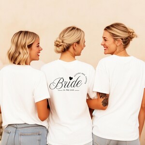 May include: A white ceramic mug with a black handle and the text "But First, Coffee" in a handwritten style. The mug is on a white surface. The mug is likely for hot beverages.