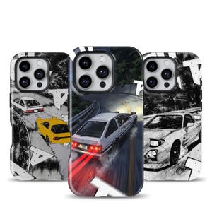 May include: Three phone cases featuring dynamic automotive illustrations. The left case shows a white and yellow car on a winding road. The center case depicts a white car drifting on a mountain pass with red taillights. The right case shows a white sports car.