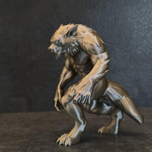 May include: A metallic bronze-colored figurine of a werewolf in a crouching, predatory stance. The creature features detailed fur texture, pointed ears, sharp claws on its hands and feet, and a long tail, captured in a dynamic pose.