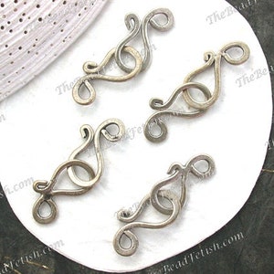 May include: Five silver-toned metal clasps with a decorative, swirling design. The clasps are arranged on a white surface.