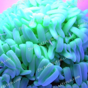 May include: A close-up of a large pile of bright green rubber bands. The rubber bands are all twisted and tangled together.