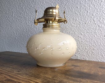 Cream hobnail Lamplighter Farms glass oil lamp with brass burner assembly.