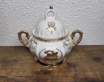 A vintage Sterling China sugar bowl with gold floral decorations
