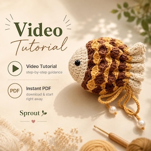 May include: A crocheted fish toy with a cream, brown, and yellow textured pattern, a black bead eye, and two yellow yarn tails with white pearl beads. Text reads: Video Tutorial, step-by-step guidance, Instant PDF, download & start right away, Sprout.