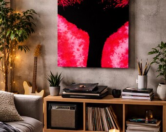 May include: Abstract art piece with a black tree-like silhouette against a vibrant red and pink background. The artwork hangs above a wooden cabinet with records, books, and a small amplifier. A guitar and a sofa are also visible.