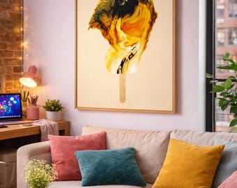 May include: Abstract art print of a popsicle with a wooden stick. The artwork features a blend of yellow, black, and white colors, framed in a natural wood frame. The painting hangs above a beige sofa with colorful throw pillows.