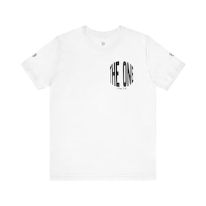 May include: White t-shirt featuring the black text "THE ONE" in a curved, stylized font on the front. Below the text is "1 Pet 2:9". The shirt has short sleeves and a crew neck.