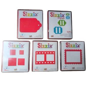 May include: A selection of Sizzix die-cutting templates, featuring shapes like tags, rectangles, and filmstrip designs. Each template has a red die-cut shape on a white background, with the Sizzix logo and product details.