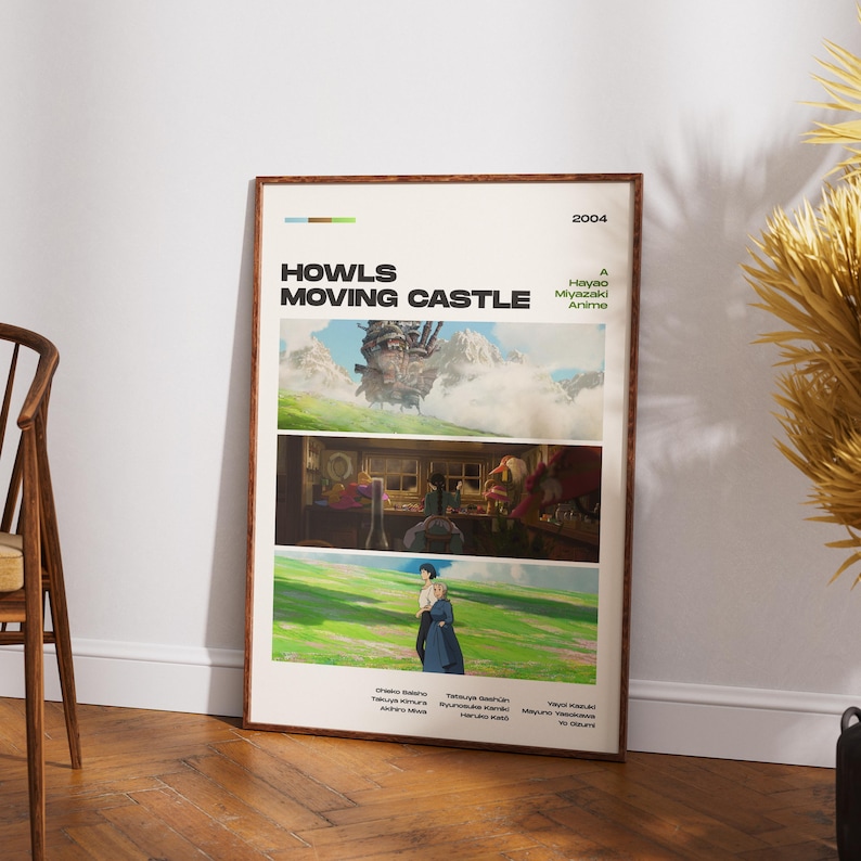 May include: A framed poster for the animated film "Howl's Moving Castle" by Hayao Miyazaki. The poster features three scenes from the movie, with the title and year 2004 at the top. The poster is displayed on a wooden floor.