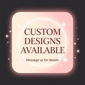 May include: A square, rounded-corner graphic with a gradient pink and peach background. The text "CUSTOM DESIGNS AVAILABLE" is in a dark red font, with the words centered. The text "Message us for details" is below the main text.