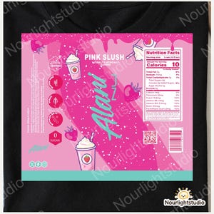 May include: Black t-shirt featuring a pink graphic with the text "PINK SLUSH" and "Alani". The graphic includes images of strawberries and a drink with a strawberry on the cup. The nutrition facts are also displayed.