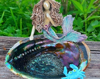 Mermaid sitting upon an Abalone shell