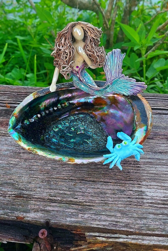 Mermaid sitting upon an Abalone shell