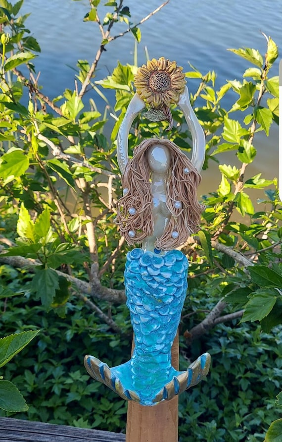 Mermaid tree topper holding a sunflower