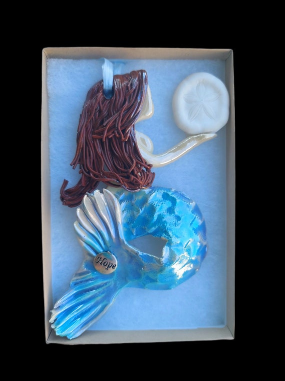 Mermaid ornament holding a Sandollar
