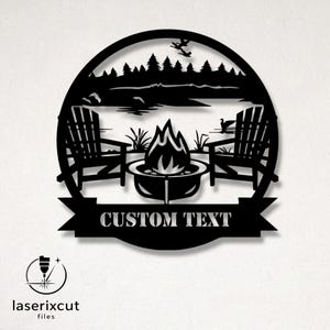 May include: Black metal wall art featuring a lakeside scene with Adirondack chairs, a fire pit, and trees. The design includes the text "CUSTOM TEXT" on a banner. The artwork is circular and includes a logo for "laserixcut files".
