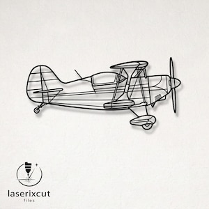 May include: A black metal wall art piece shaped like a biplane, featuring a detailed wireframe outline of the aircraft with two stacked wings, a front propeller, a cockpit, and landing gear. The design includes the text laserixcut files.