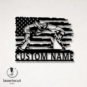 May include: Black metal wall art featuring two wrestlers in action against a backdrop of the American flag. The words "CUSTOM NAME" are displayed below the wrestlers. The logo for laserixcut files is in the lower left corner.