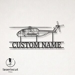 May include: A black metal wall art piece featuring a detailed outline of a helicopter silhouette positioned above a horizontal bar with the text CUSTOM NAME in bold capital letters, supported by two vertical stems connecting the helicopter to the bar.
