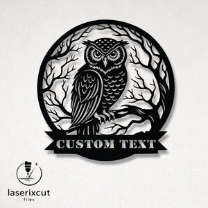 May include: Black laser-cut owl wall art. The owl is perched on a branch within a circular frame of tree branches. A banner at the bottom reads "CUSTOM TEXT". The laserxcut files logo is in the lower left corner.