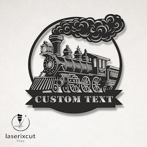 May include: Black metal train silhouette with a banner that reads "CUSTOM TEXT" inside a circular frame. The train features detailed wheels, a smokestack with billowing smoke, and a decorative design. The logo "laserixcut files" is in the lower left corner.