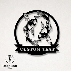 Pode incluir: Arte de parede em metal preto com dois peixes koi num design circular. Os peixes têm marcas a preto e branco. Uma faixa abaixo do círculo diz "CUSTOM TEXT". O logótipo "laserixcut files" está no canto inferior esquerdo.