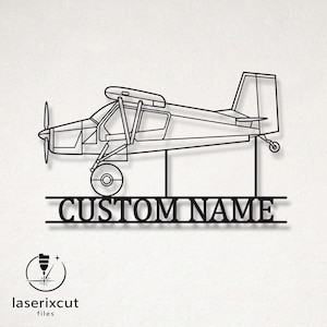 May include: A black metal wall art piece featuring a side profile outline of a single-engine propeller airplane. Below the aircraft, a horizontal bar contains the text CUSTOM NAME in a bold, serif font, supported by two vertical metal rods.