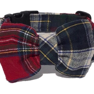 May include: A plaid dog collar with a matching bow tie. The collar features a black plastic buckle and a silver metal D-ring. The bow tie and collar are made of a red, green, blue, and yellow plaid fabric.