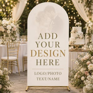 May include: A tall, arched, white display sign with a gold metal base. The sign features the gold text ADD YOUR DESIGN HERE, followed by a horizontal line and the text LOGO/PHOTO TEXT/NAME. A faint, faded image of a couple is visible.