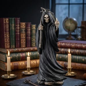 May include: A grim reaper figurine wearing a black hooded robe, holding a scythe in one hand and gesturing with the other. The skeleton figure has a white skull and bony hands. It stands on a dark base, positioned among several vintage books.