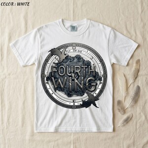 May include: White t-shirt featuring a circular design with the text "FOURTH WING" in a stylized font. The design includes bat silhouettes and the phrase "FLY...OR DIE". The shirt is made of a soft material.