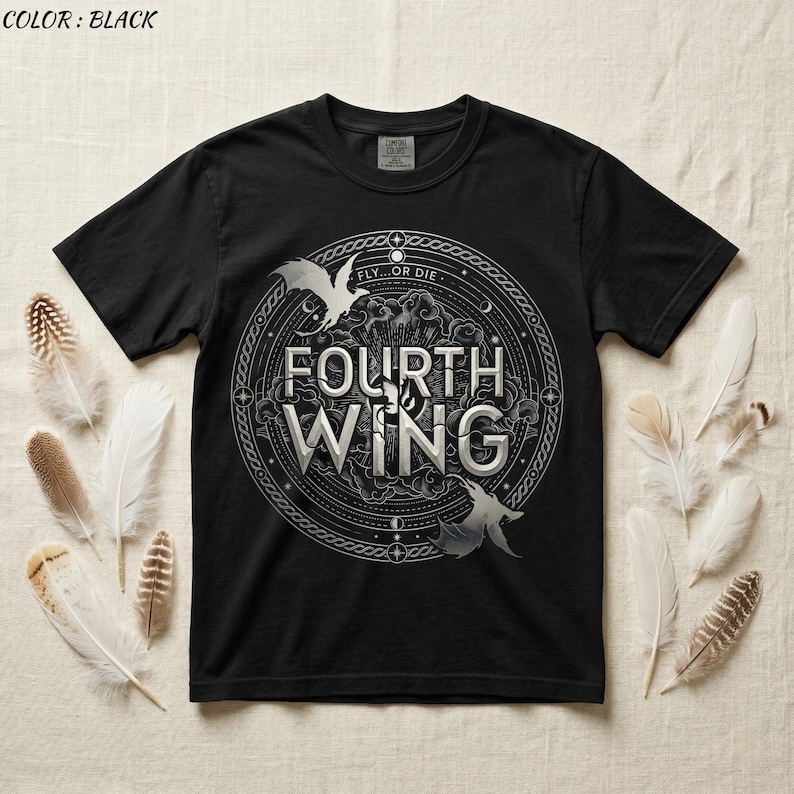 May include: Black t-shirt featuring a circular design with the text "FOURTH WING" in silver lettering. The design includes two stylized winged creatures and the words "FLY...OR DIE". The shirt is surrounded by feathers.