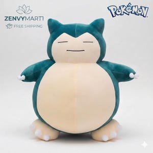 May include: A plush Snorlax Pok&eacute;mon character in teal and cream colors. The stuffed animal has a rounded body, closed eyes, and small arms and feet. The Pok&eacute;mon logo is visible in the upper right corner.
