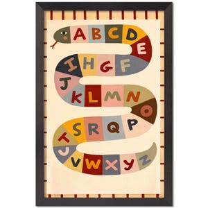 May include: A framed art print featuring a colorful snake-shaped alphabet. The snake's body is segmented into various colors, each displaying a letter from A to Z. The background is a light beige with a striped border, and the frame is black.