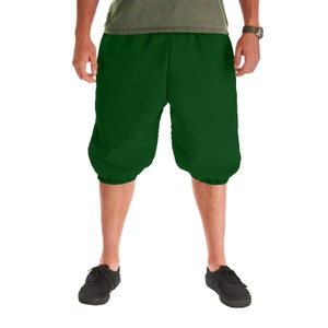 May include: A pair of dark green, knee-length, cuffed shorts made of a soft, comfortable fabric.