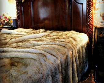 May include: A luxurious faux fur throw blanket in a brown and white color scheme, draped over a wooden bed frame. The blanket has a soft, plush texture and is perfect for adding warmth and style to any bedroom.