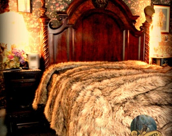 May include: A luxurious brown faux fur throw blanket on a wooden bed frame with a carved headboard. The blanket is made of soft, plush faux fur and has a natural, rustic look. The blanket is perfect for adding warmth and style to any bedroom.