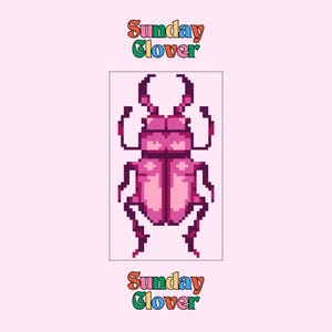May include: A pixelated illustration of a pink beetle with large pincers, set against a light pink background. The text "Sunday Clover" appears above and below the beetle in a colorful, retro font.