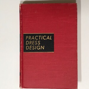 May include: A red hardcover book with the title "PRACTICAL DRESS DESIGN" in gold lettering on a black background.