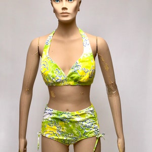 May include: A green and yellow floral print bikini with a halter top and high-waisted bottoms.